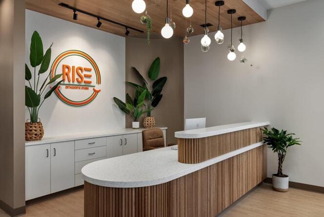 An image of the front desk at RISE with plants and soft lighting.